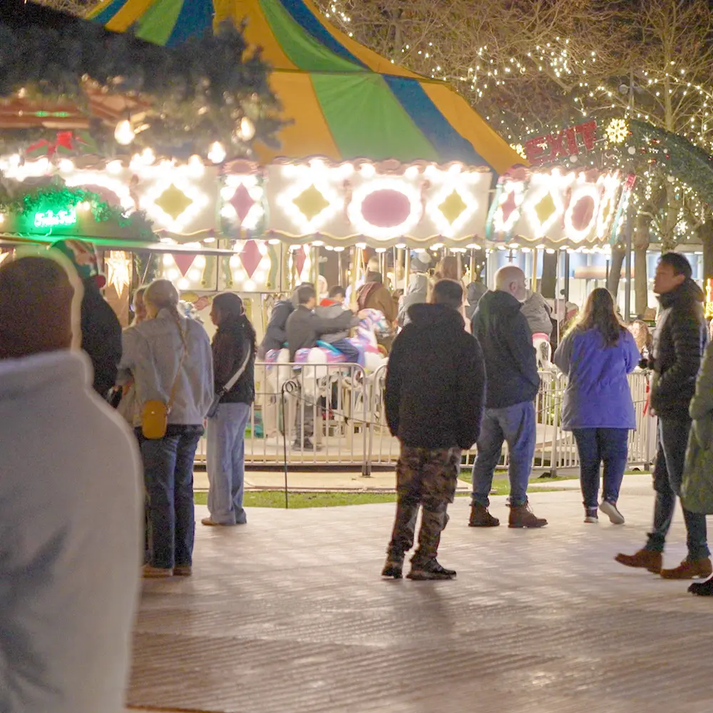 Carousel at night with bright lights.